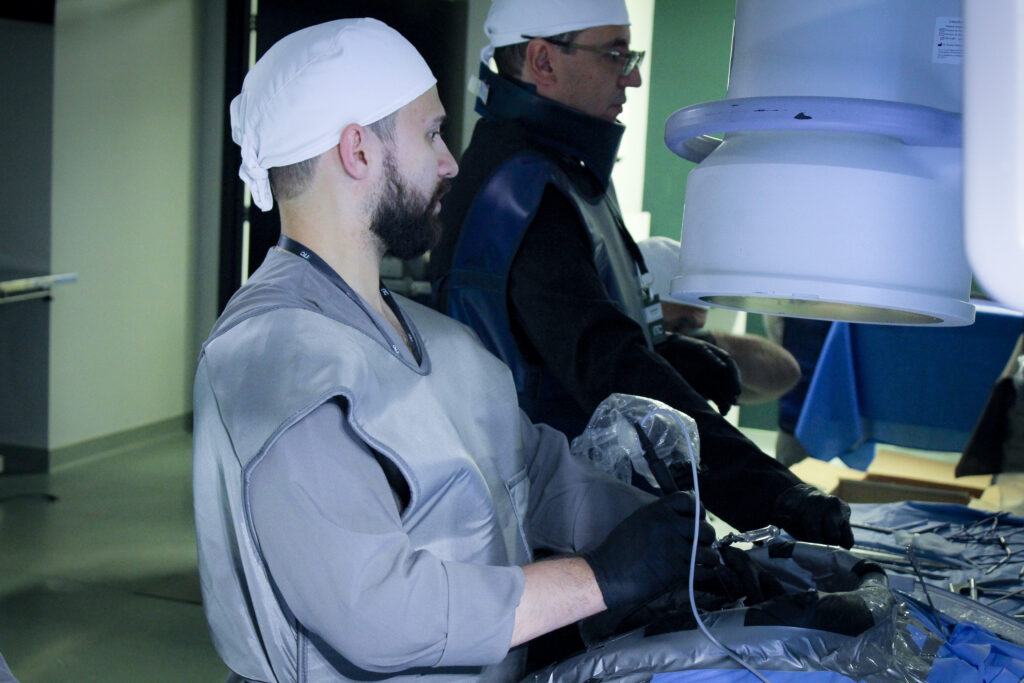 Na imagem você vê o primeiro curso Hands On de UBE da América Latina sendo realizado pela Surg+ em dezembro de 2023, ao lado de grandes nomes da Endoscopia Biportal. À direita está o Dr. Regis Tavares, um dos pioneiros no Brasil. Ao seu lado esquerdo, realizando o treinamento Hands On, está um dos alunos do primeiro curso de UBE no Brasil.
